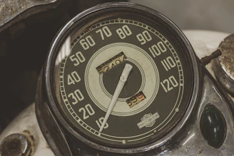 black and white analog gauge displaying 10
