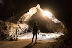 woman standing inside cave