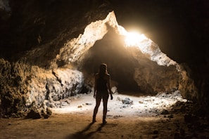 woman standing inside cave