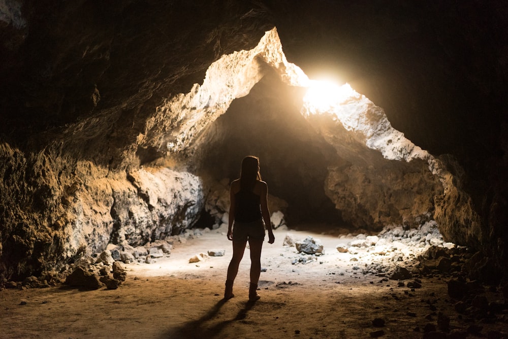 woman standing inside cave