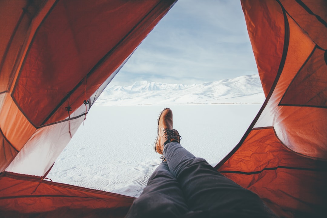 person inside red and white tent, camper in deer creek reservation