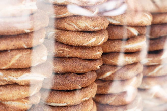Close-up of crispy, sesame-covered simit stacked invitingly on a rustic tray