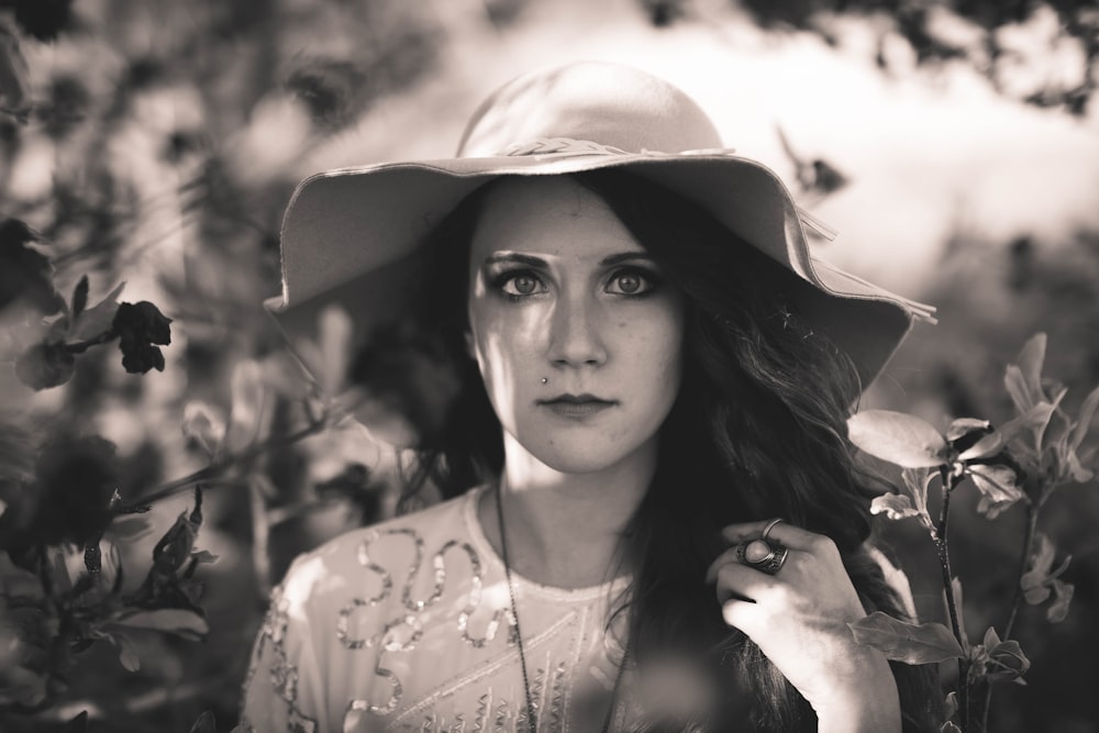 grayscale photography of woman wearing sun hat