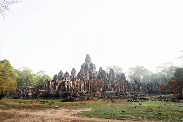 An ancient stone-carved temple facade surrounded by lush jungle under a deep obsidian twilight sky.