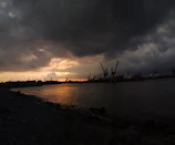 A dramatic black and white photo of Kochi’s bustling harbor at sunset.