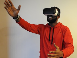 man wearing white VR headset while lifting right hand