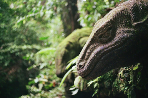 Players strategizing together in the game's lush prehistoric environment.