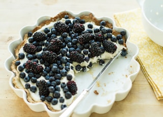 blueberry pie on plate with knife