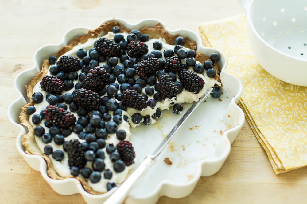blueberry pie on plate with knife