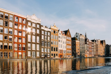assorted-color buildings beside body of water
