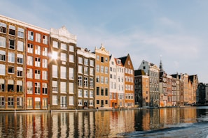 assorted-color buildings beside body of water