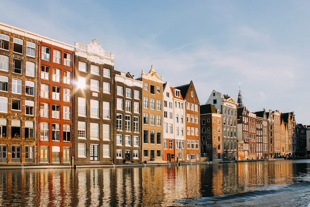 assorted-color buildings beside body of water