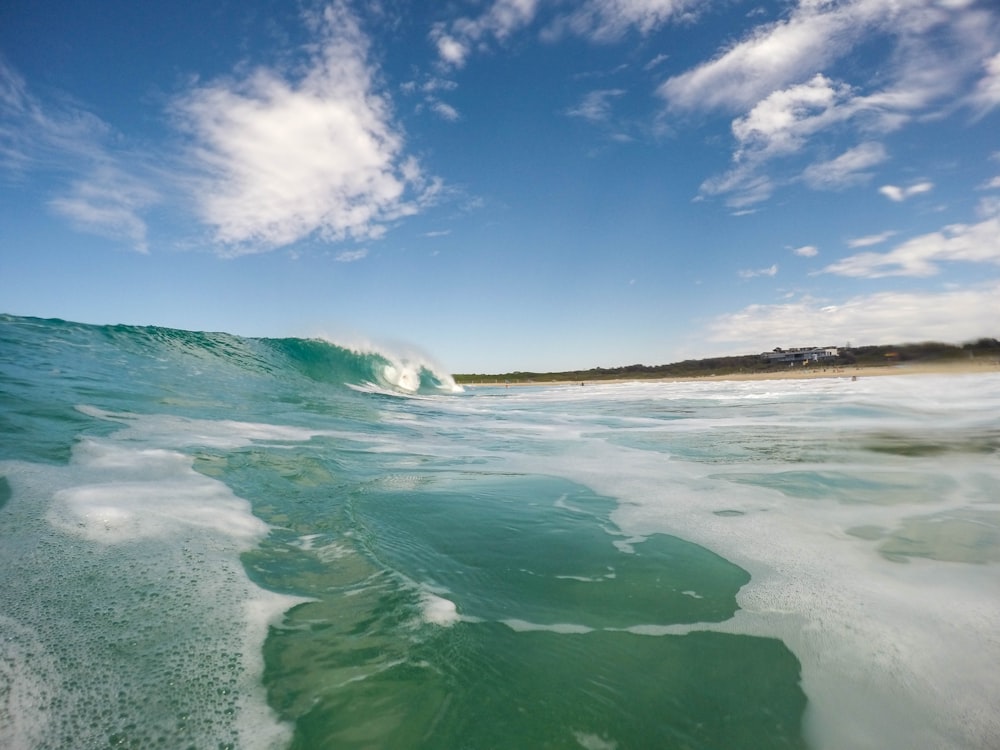 A large wide wave coming in to shore.