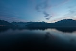 Sunrise over the serene lakes of Skardu, with mountains reflecting on crystal-clear water.
