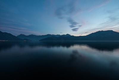 Sunrise over the serene lakes of Skardu, with mountains reflecting on crystal-clear water.