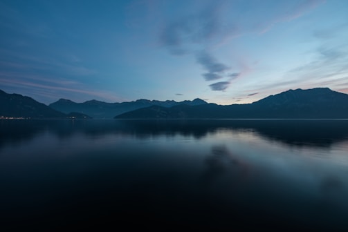 A serene sunrise over a quiet mountain lake, symbolizing new beginnings and self-reflection.