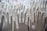 A collection of white rubber glove molds, with some of them showing signs of dirt or discoloration. The molds are arranged closely together, forming a repetitive pattern.
