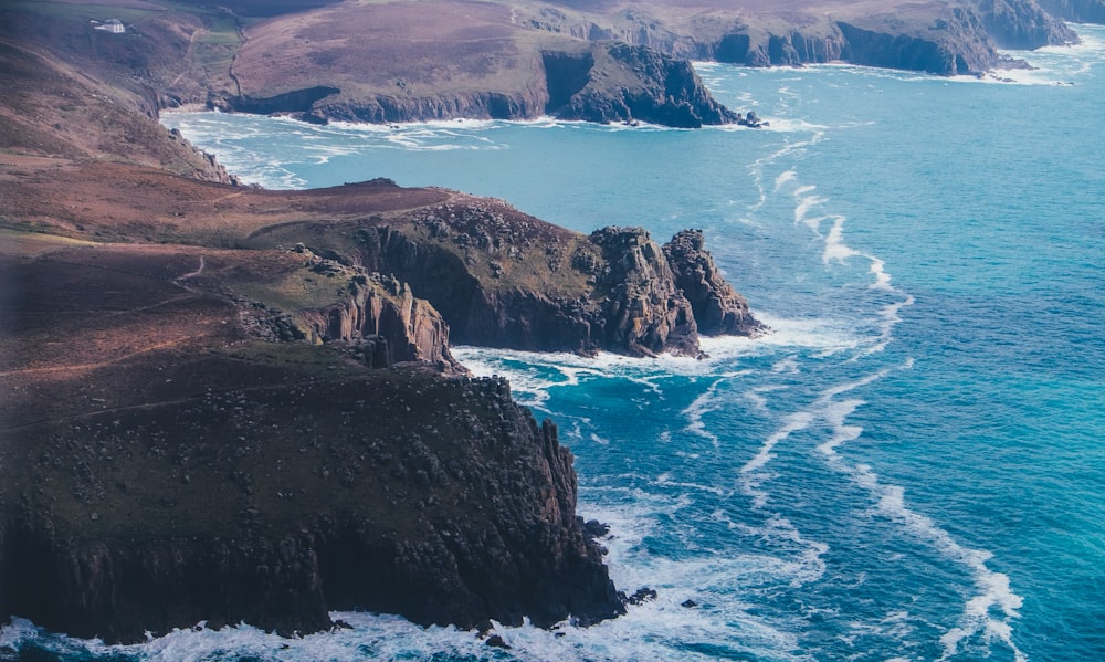 photography of mountain range and seashore during daytime