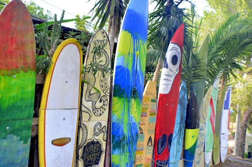 A collection of colorful surf accessories displayed on a wooden table.