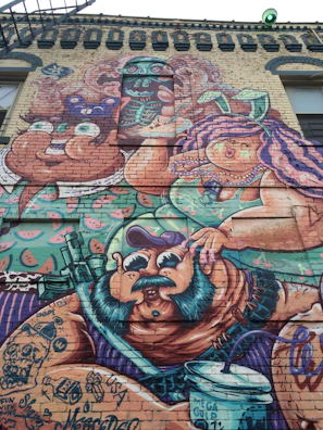 Colorful urban mural painted on a brick wall in Toluca, showcasing vibrant characters and street vibe.