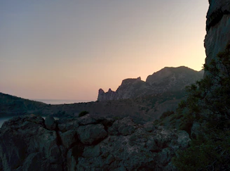 A rugged mountain landscape at dawn, symbolizing strength and enduring commitment.