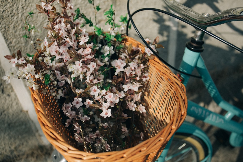 pink flowers on brown wicker basket