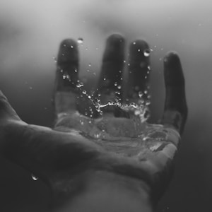 time lapse photography of water hitting left palm