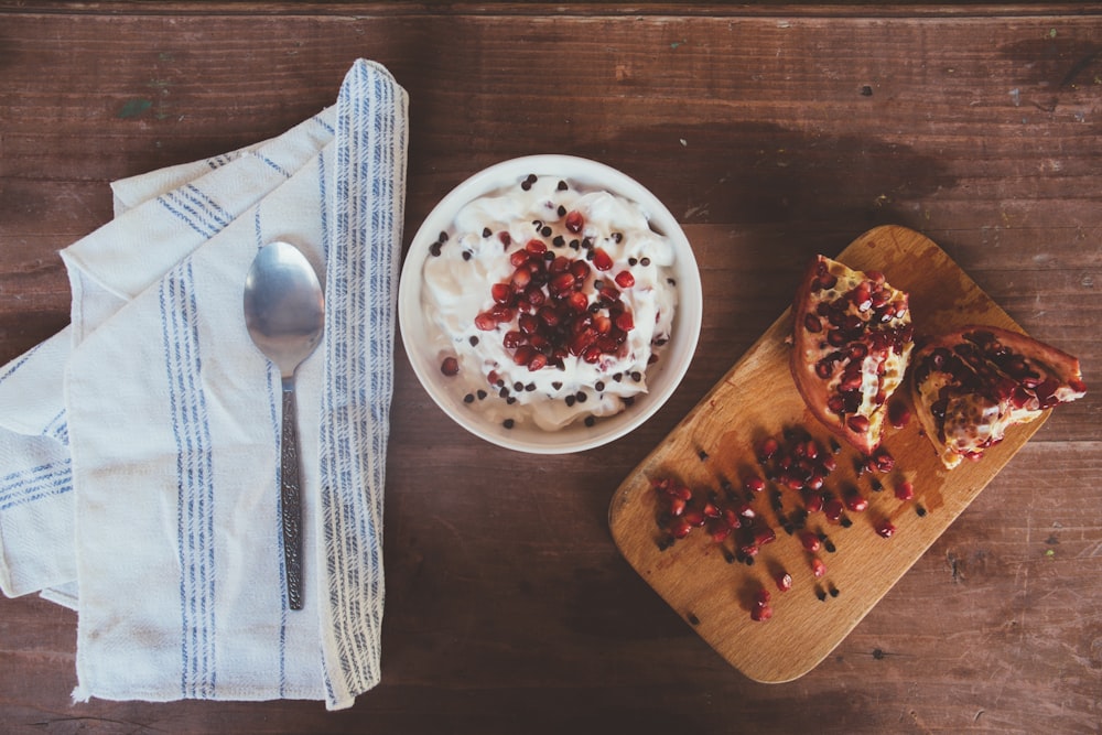 pomegranate fruit on brown wooden board