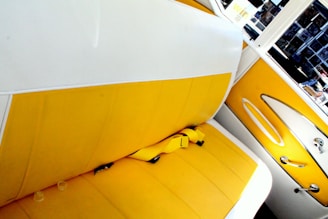 Car interior showing vibrant yellow and blue seat covers fitting perfectly.
