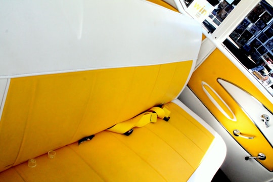 Car interior showing vibrant yellow and blue seat covers fitting perfectly.