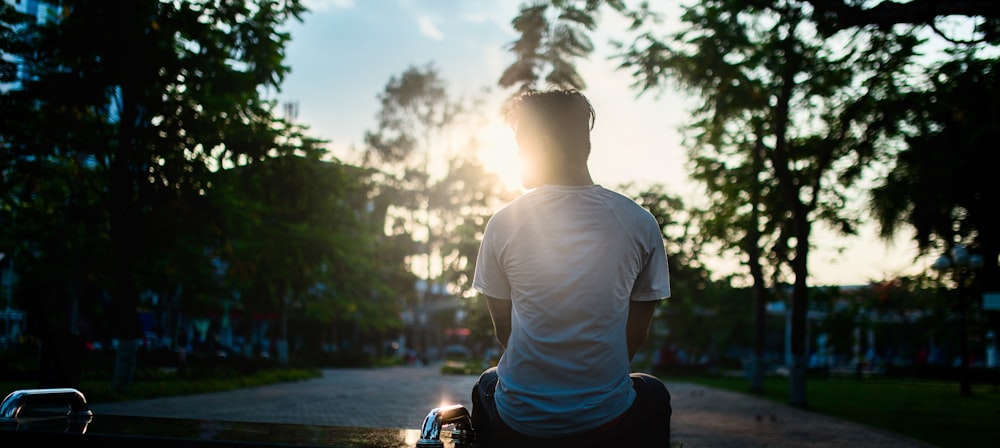 man sitting on road