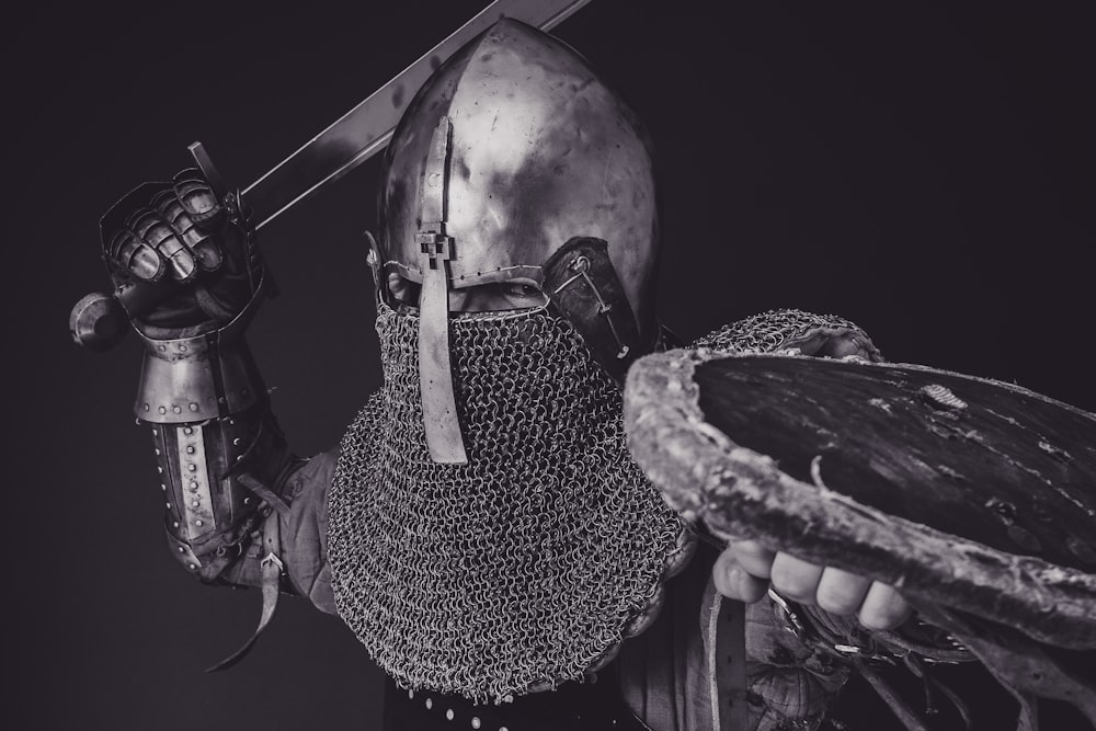 man with steel and chainmail armor holding sword