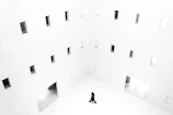 A minimalist editorial shot of a model walking through a luxury lifestyle setting with neutral interiors and calm ambiance.