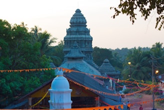 A serene view of the planned temple site framed by maroon and saffron banners fluttering gently.