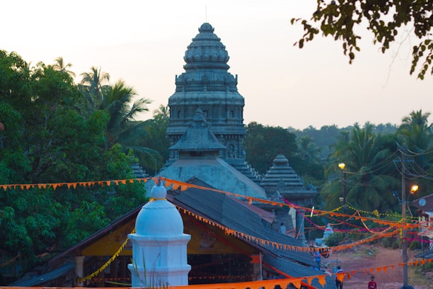 A serene view of the planned temple site framed by maroon and saffron banners fluttering gently.