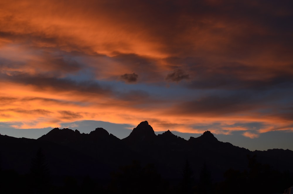 photo of mountains during sunset