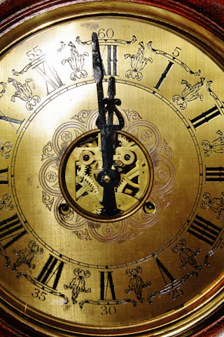 A close-up of a vintage clock face with moving gears symbolizing steady progress and balance.