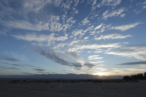 A drone shot capturing the vastness of a desert landscape at golden hour.