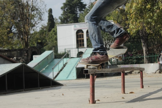 person skating on rail during daytime in Bosque Cuauhtémoc Mexico