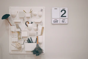 Well-organized cleaning supplies and schedule board for rental property maintenance