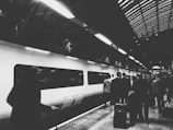 A train station platform bustling with passengers boarding a train