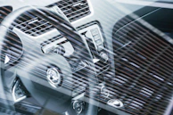 Driver's perspective showing the steering wheel, gear shift, and touch screen infotainment system.