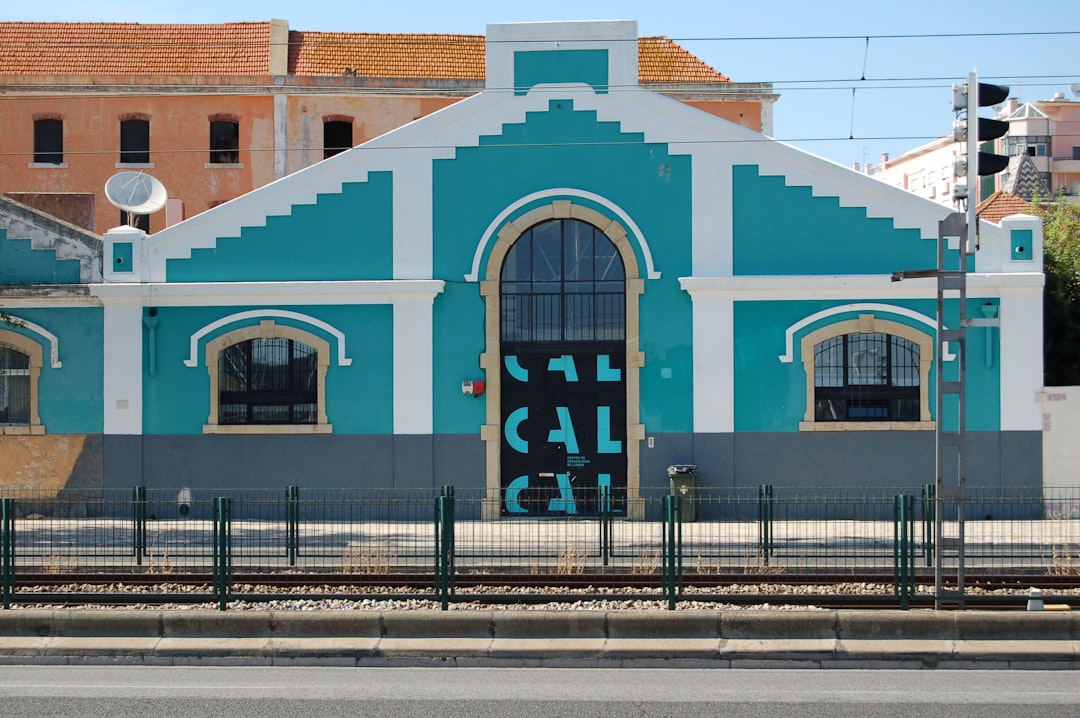 teal house near railway