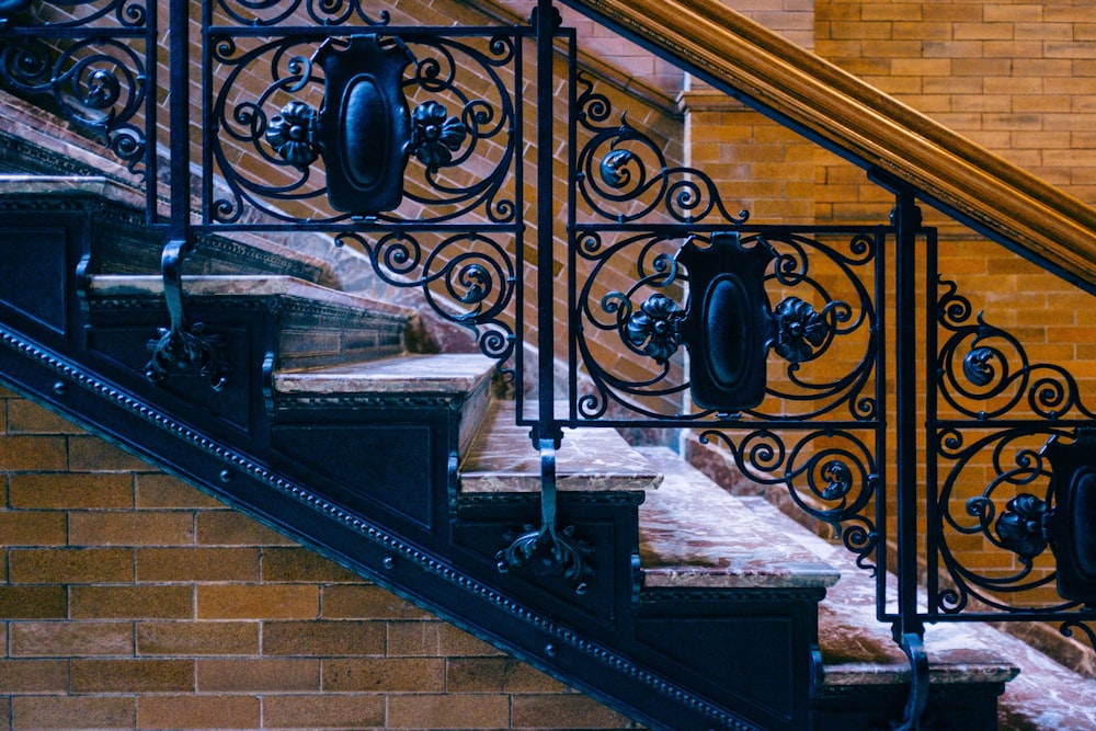 black metal railings on brown concrete staircase