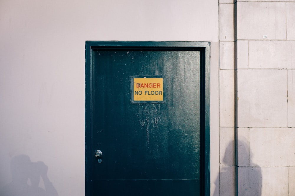 blue wooden door with gold and black signage