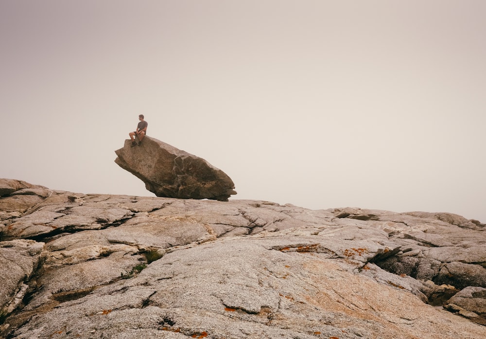 person siting on top of rock