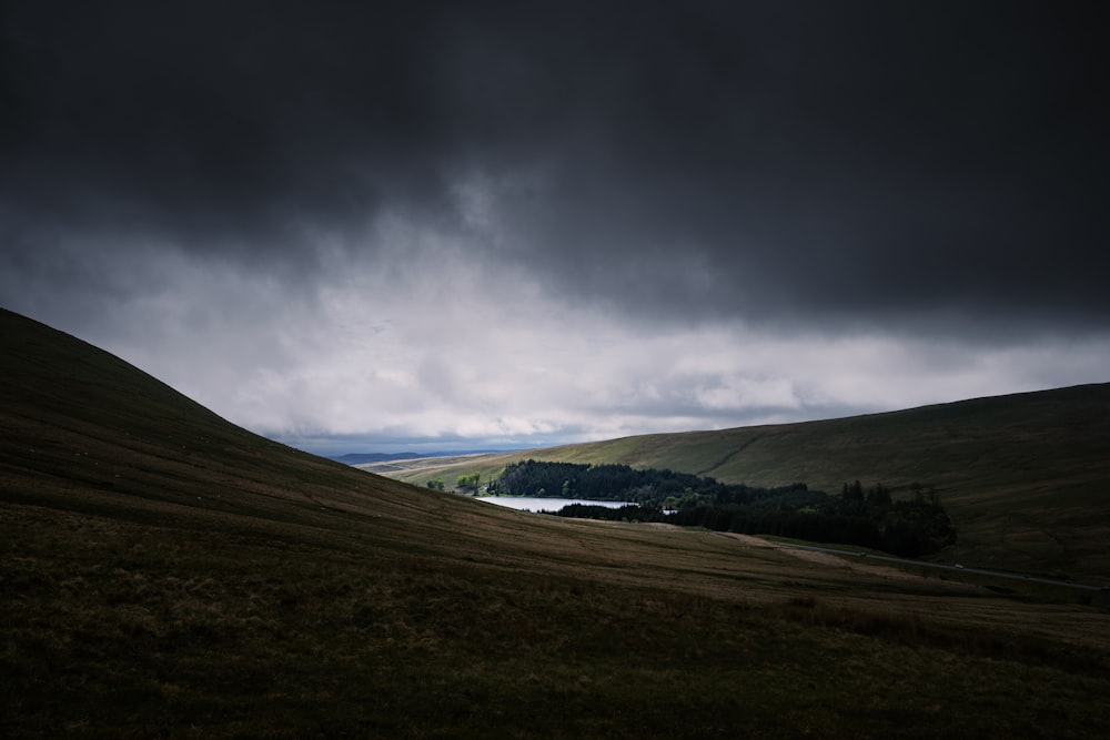 brown mountain under cumulos clouds