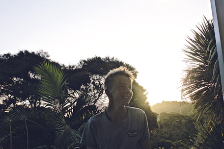 Smiling local guide showing tourists around a lush Lombok village.