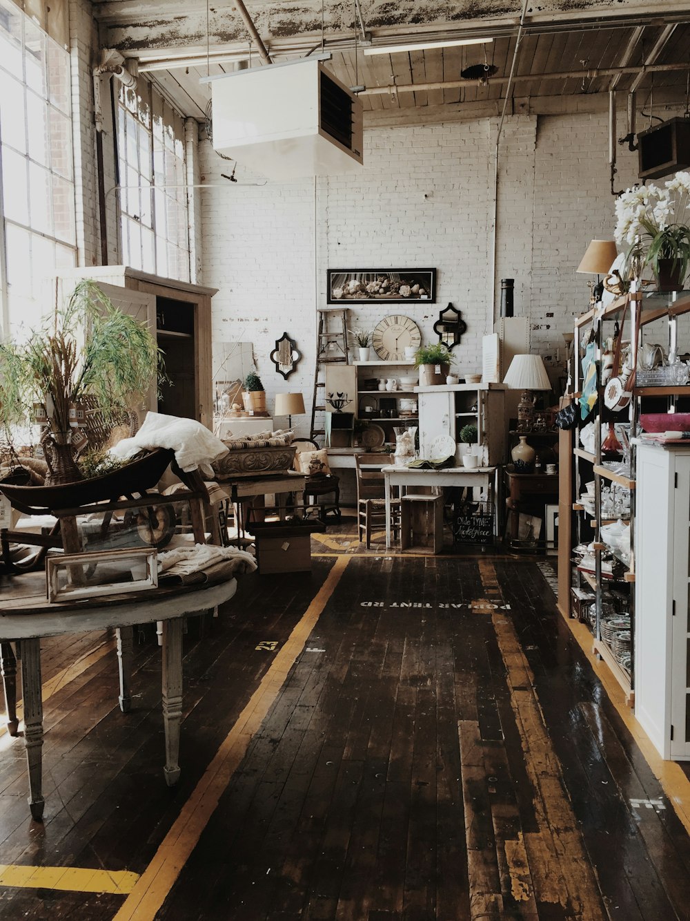 a room filled with furniture and lots of windows