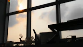 Soft morning light illuminating a workspace scattered with creative tools and memories.